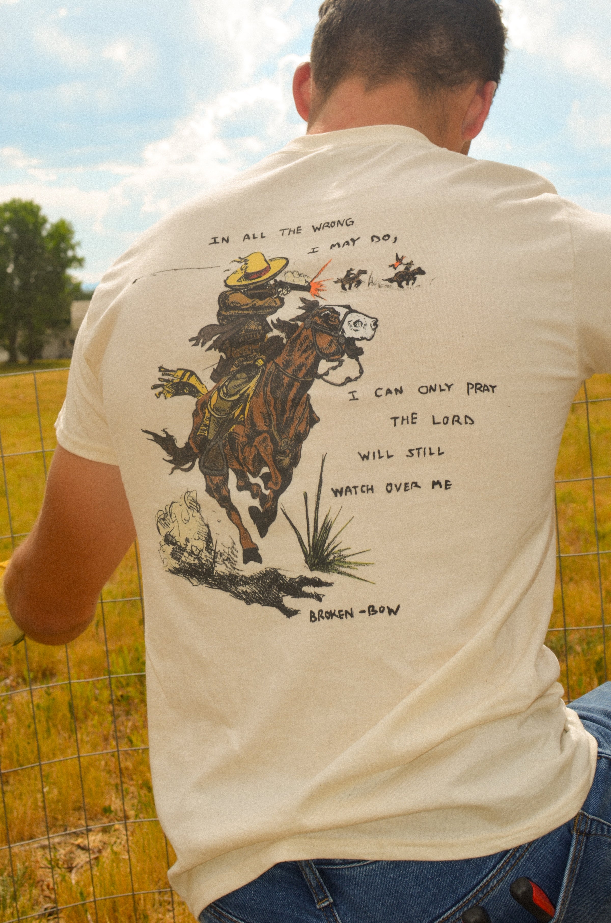 In All the Wrong I May Do- A Christian piece of apparel featuring a design of a skeleton cowboy and Bible verse