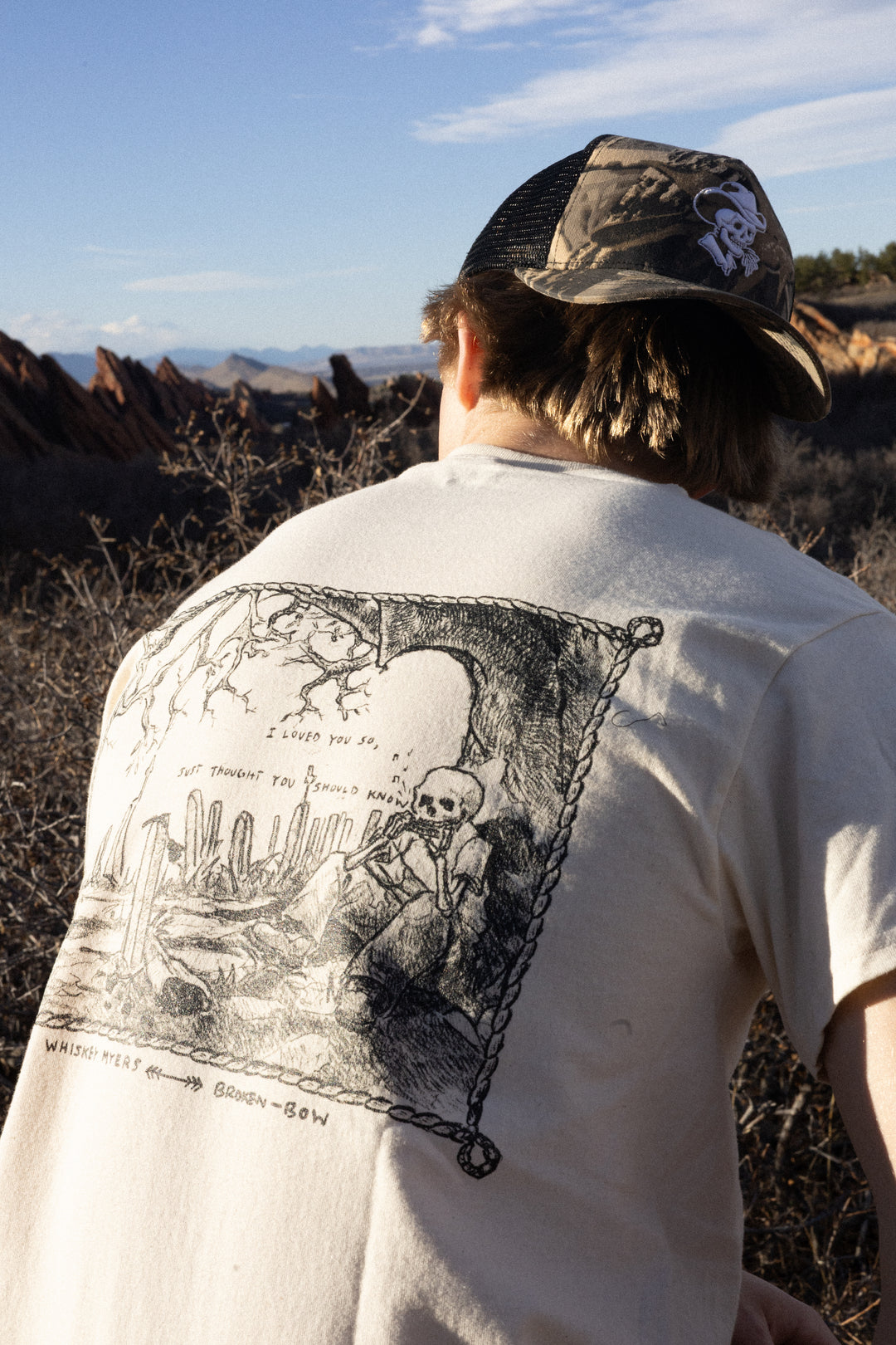 Whiskey Myers x Broken Bow: Broken Window Serenade- A official t-shirt for the song "Broken Window Serenade" by Whiskey Myers that features a design of a skeleton sitting underneath a tree with the words "I loved you so"
